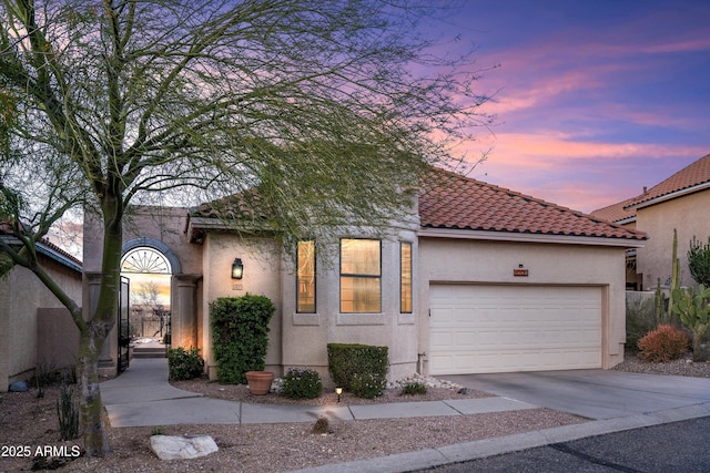 1705 E Deer Shadow Ln, Tucson, AZ 85737 - mediterranean / spanish-style house featuring stucco siding, an attached garage, driveway, and a tiled roof