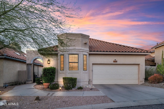 1705 E Deer Shadow Ln, Tucson, AZ 85737 - mediterranean / spanish-style home with a tiled roof, stucco siding, concrete driveway, and a garage