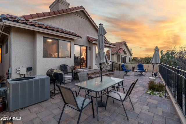 1705 E Deer Shadow Ln, Tucson, AZ 85737 - patio terrace at dusk featuring cooling unit, a patio, outdoor dining space, and grilling area