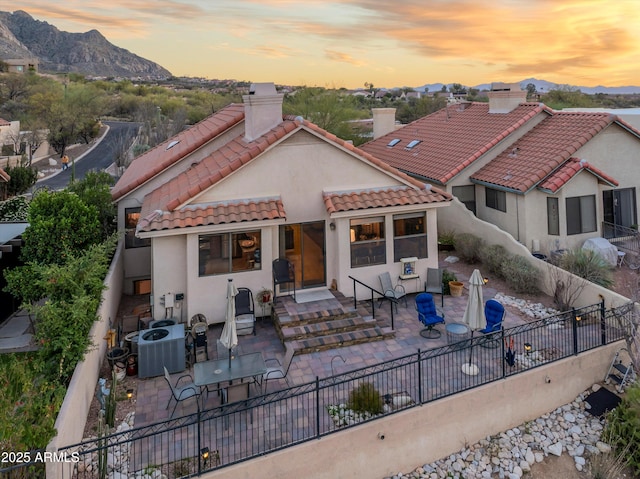 1705 E Deer Shadow Ln, Tucson, AZ 85737 - view of front of home with a patio, a mountain view, a chimney, and central AC unit