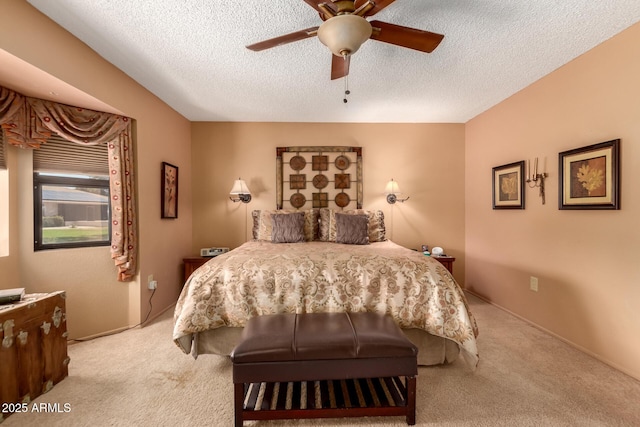 bedroom featuring a ceiling fan, a textured ceiling, and carpet