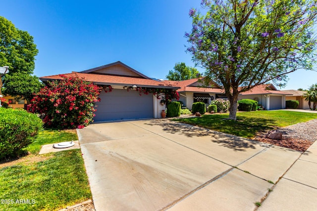 ranch-style house featuring a front lawn, driveway, and a garage