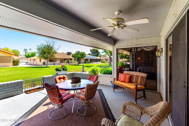 view of patio featuring outdoor dining space, ceiling fan, and a residential view