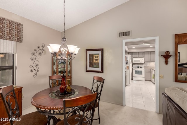 dining area with visible vents, a notable chandelier, light colored carpet, and high vaulted ceiling