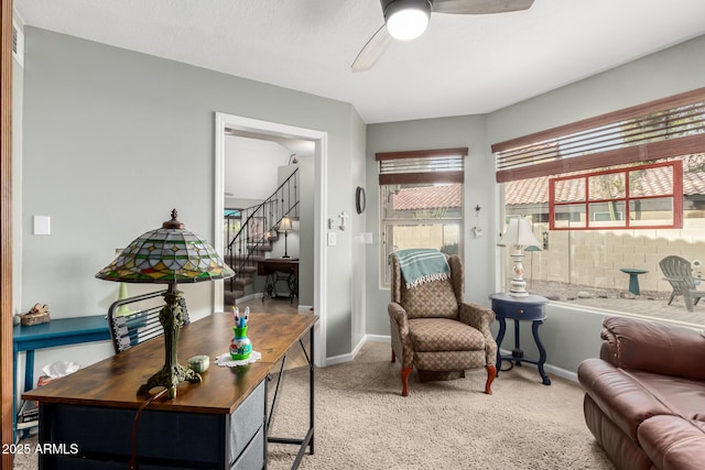 living area with ceiling fan and carpet floors