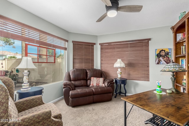 living room with ceiling fan and carpet