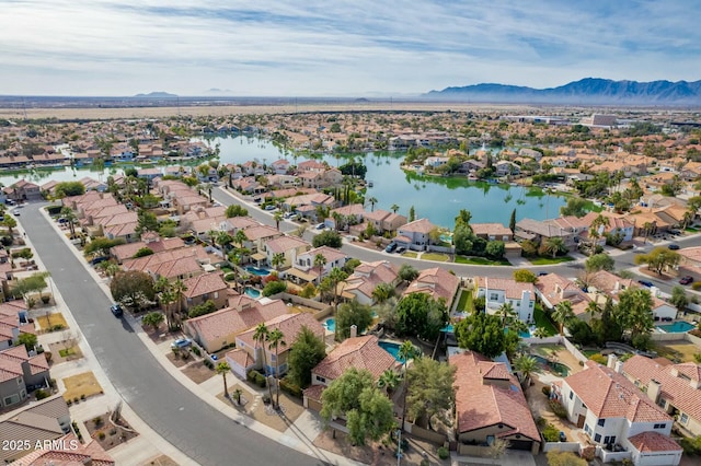 aerial view featuring a water and mountain view