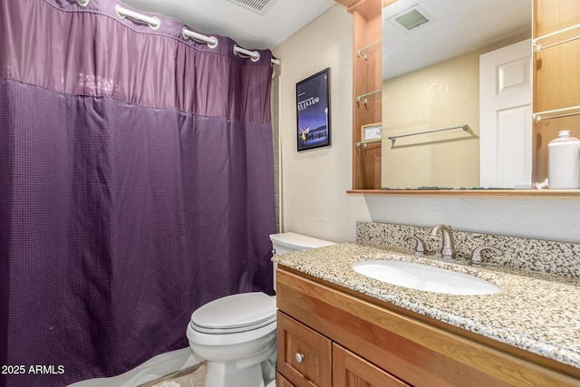 bathroom featuring vanity, toilet, and walk in shower