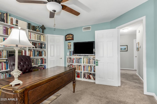 carpeted home office with ceiling fan