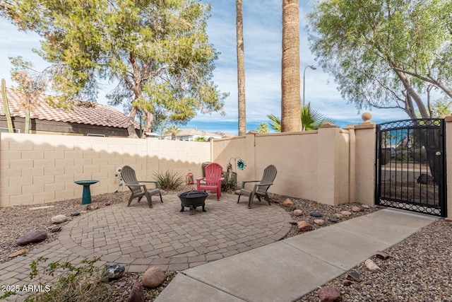 view of patio featuring a water view and an outdoor fire pit