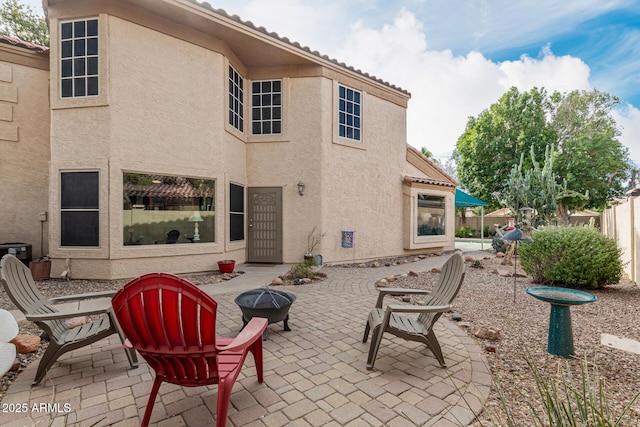 view of patio / terrace featuring an outdoor fire pit