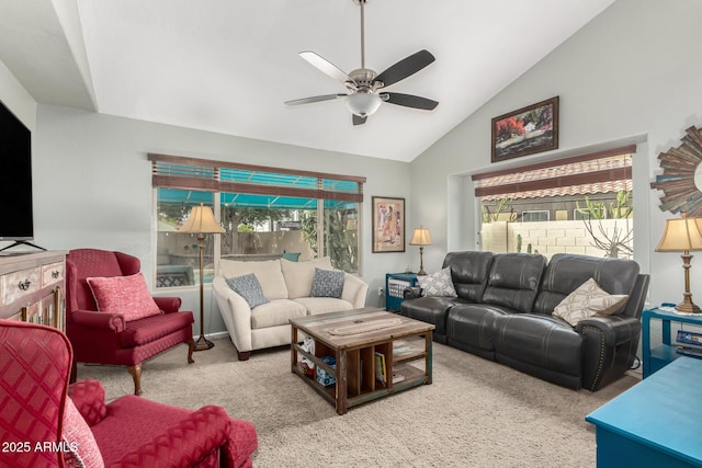 carpeted living room with ceiling fan and vaulted ceiling