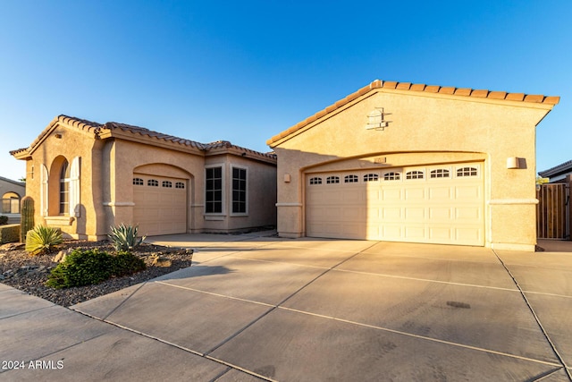 mediterranean / spanish home featuring a garage