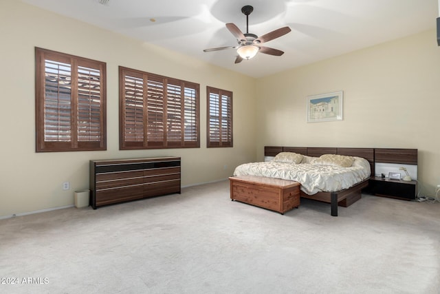 bedroom with ceiling fan and light colored carpet