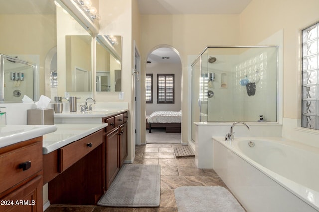 bathroom featuring vanity and shower with separate bathtub