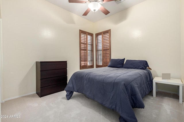 bedroom with ceiling fan and light carpet