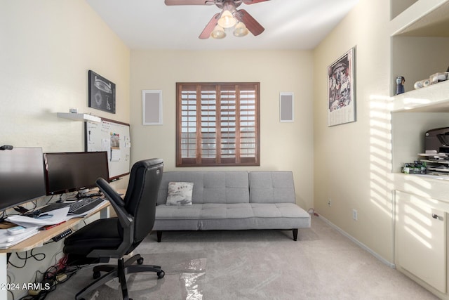 carpeted home office featuring ceiling fan