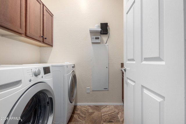 washroom with washer and dryer and cabinets