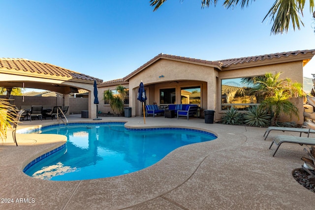 view of pool with an outdoor living space and a patio area