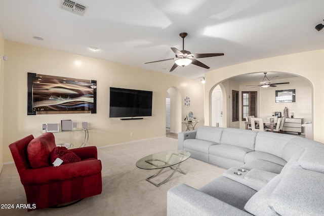 living room featuring ceiling fan and light colored carpet