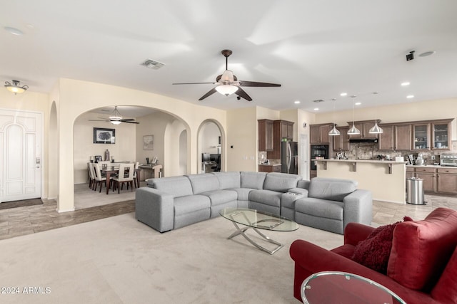 carpeted living room featuring ceiling fan