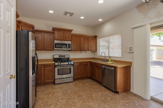 kitchen with visible vents, recessed lighting, light countertops, a sink, and appliances with stainless steel finishes