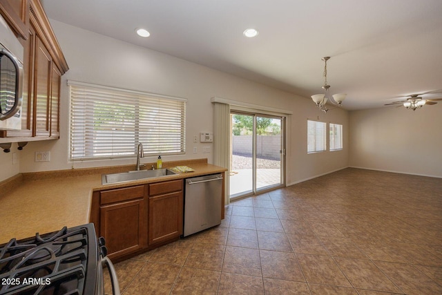 kitchen featuring a sink, light countertops, brown cabinetry, and stainless steel appliances