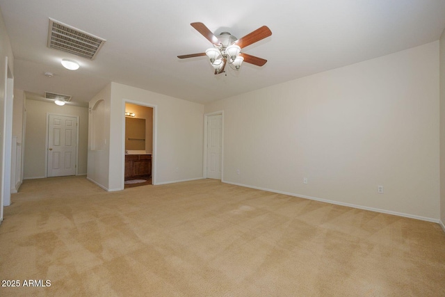 spare room featuring visible vents, baseboards, and light carpet