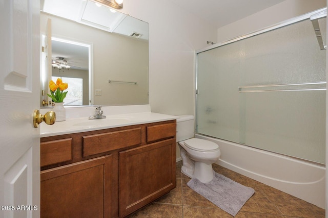 full bathroom featuring visible vents, tile patterned flooring, vanity, toilet, and shower / bath combination with glass door