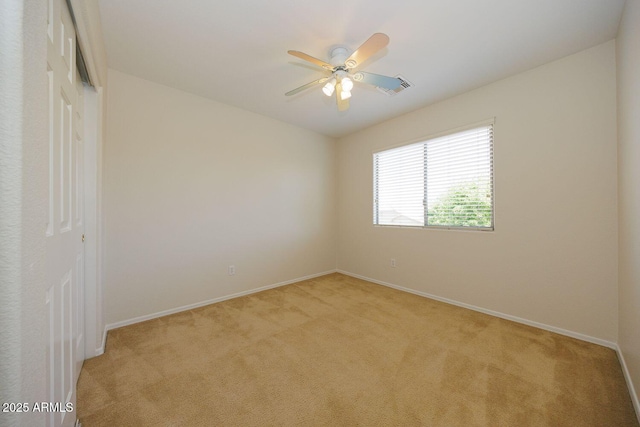 unfurnished room with visible vents, baseboards, and light carpet