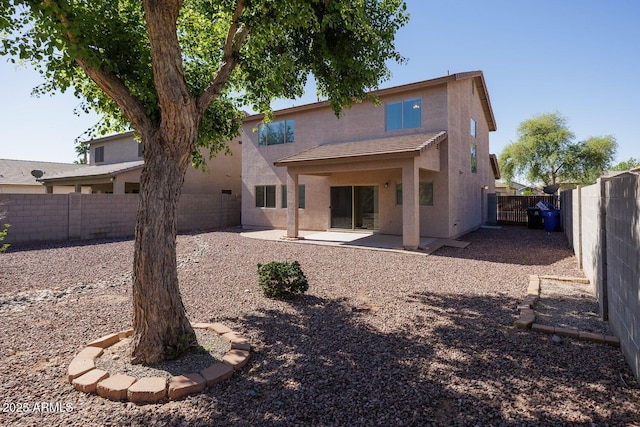 back of house with a patio, a fenced backyard, stucco siding, and a tiled roof