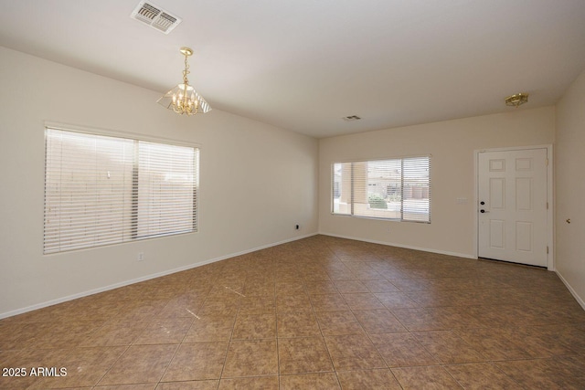 spare room featuring visible vents, baseboards, tile patterned floors, and a chandelier