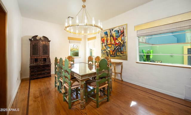 dining space with a notable chandelier and wood-type flooring