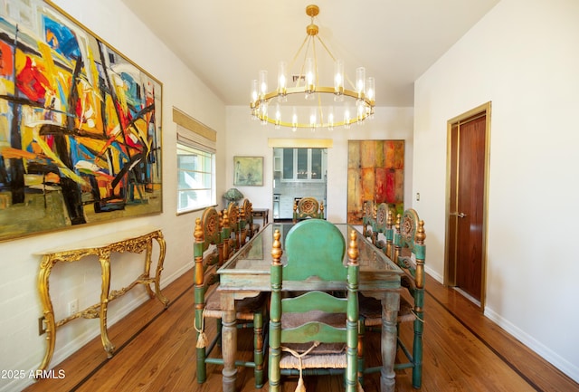 dining space with an inviting chandelier and hardwood / wood-style flooring