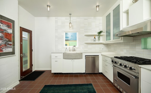 kitchen featuring sink, hanging light fixtures, wall chimney range hood, stainless steel appliances, and white cabinets