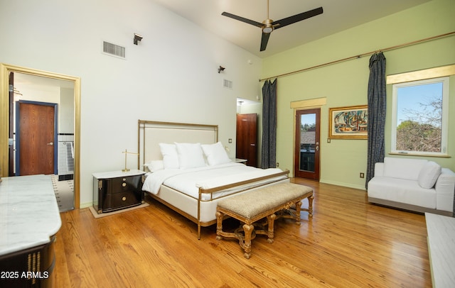 bedroom with light hardwood / wood-style flooring and high vaulted ceiling