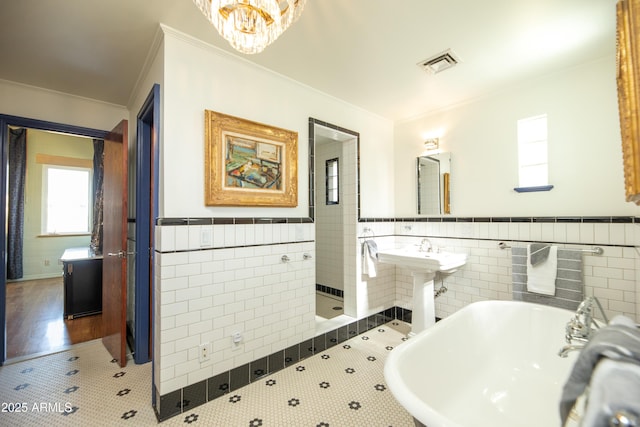 bathroom with tile walls, sink, tile patterned floors, and ornamental molding