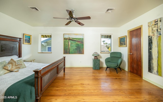 bedroom with ceiling fan and light hardwood / wood-style floors