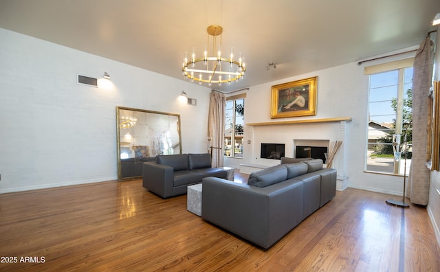 living room with hardwood / wood-style flooring and a notable chandelier