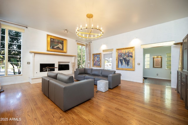 living room featuring a notable chandelier and light hardwood / wood-style flooring