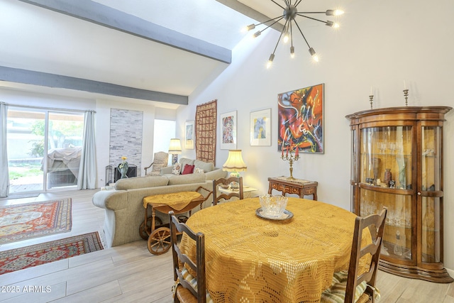 dining room featuring an inviting chandelier, vaulted ceiling with beams, and light wood finished floors