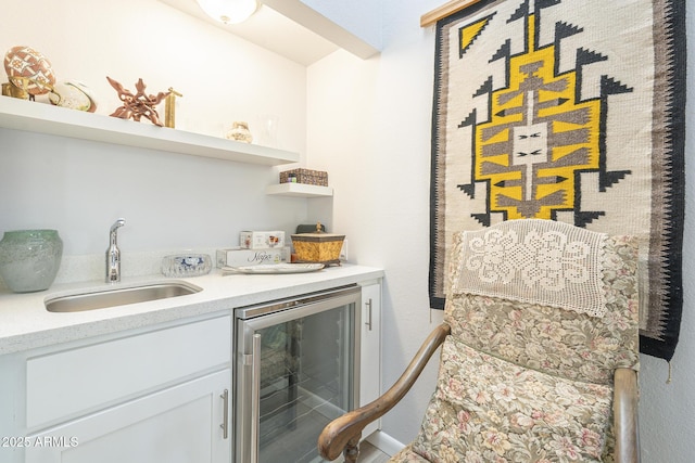 interior space featuring beverage cooler, indoor wet bar, and a sink