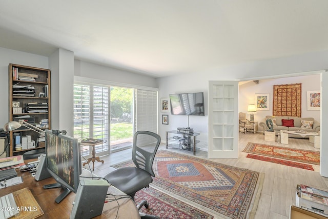 office with french doors and wood finished floors