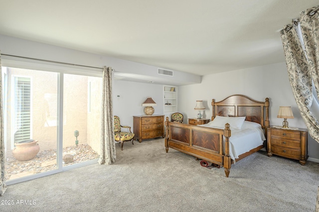 carpeted bedroom featuring access to outside and visible vents