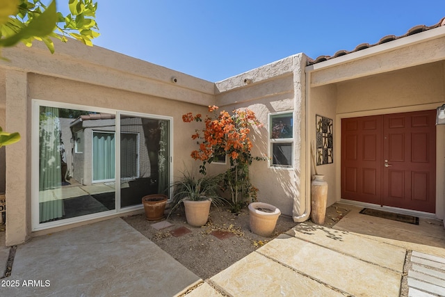 doorway to property with stucco siding