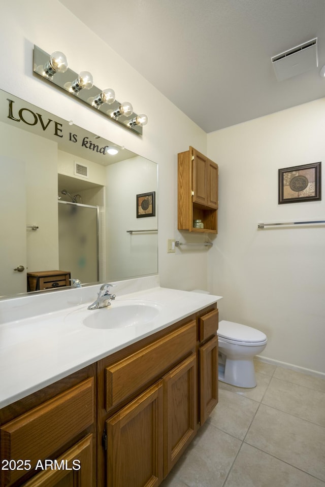 bathroom featuring vanity, tile patterned floors, a shower with door, and toilet