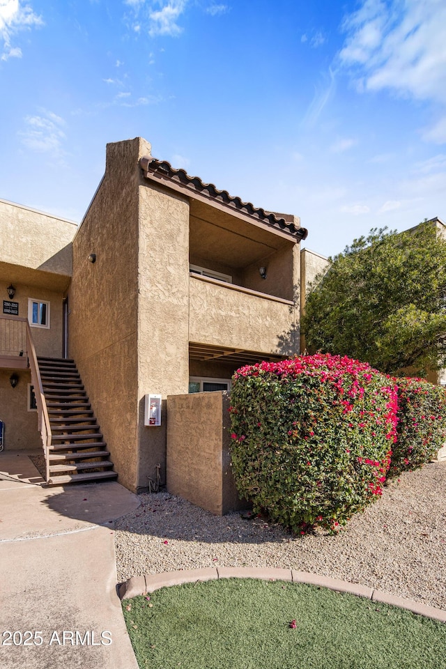 view of home's exterior with a balcony