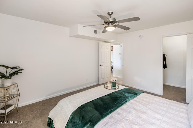 bedroom with ceiling fan, a walk in closet, a closet, and carpet floors