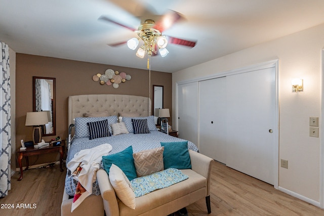 bedroom with light wood-type flooring, a closet, and ceiling fan