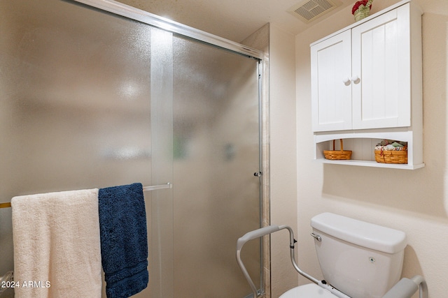 bathroom featuring toilet and walk in shower